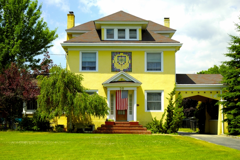 Bright Yellow House American Flag